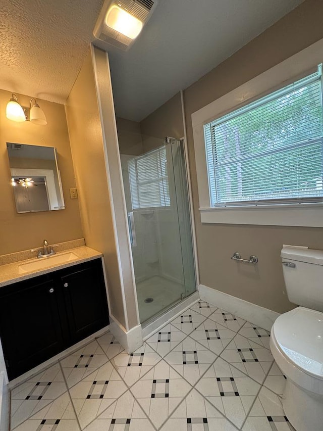 full bathroom featuring tile patterned floors, baseboards, and a stall shower