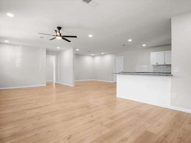 unfurnished living room with ceiling fan and light hardwood / wood-style flooring