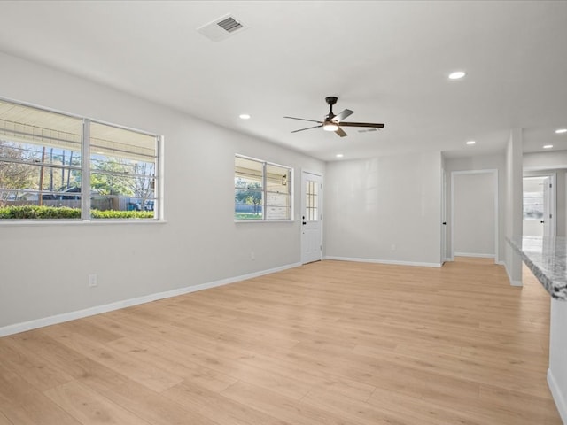 spare room featuring ceiling fan and light hardwood / wood-style floors