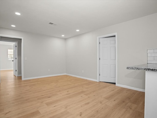 spare room with light hardwood / wood-style floors