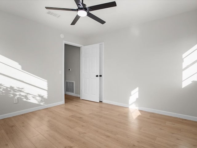 empty room featuring ceiling fan and light hardwood / wood-style floors