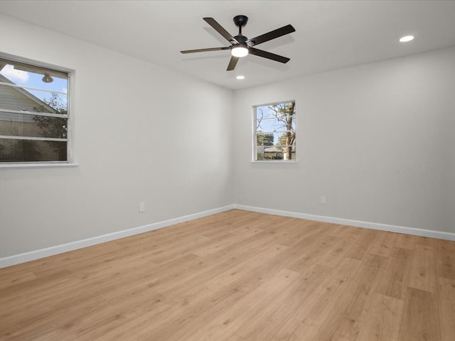 spare room with ceiling fan and light wood-type flooring