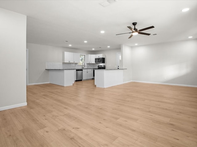 unfurnished living room with ceiling fan and light wood-type flooring