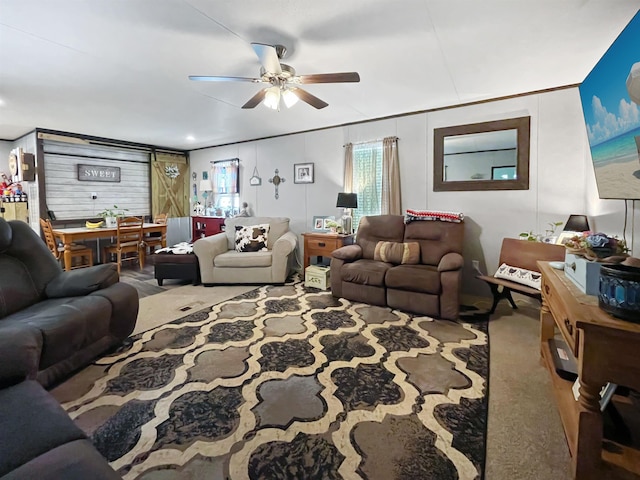 carpeted living room with ceiling fan