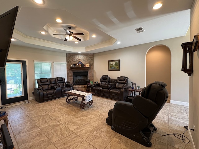 300 Deer Trace Blvd, Diboll, TX 75941 - living room with arched walkways, ceiling fan, a brick fireplace, recessed lighting, and a raised ceiling