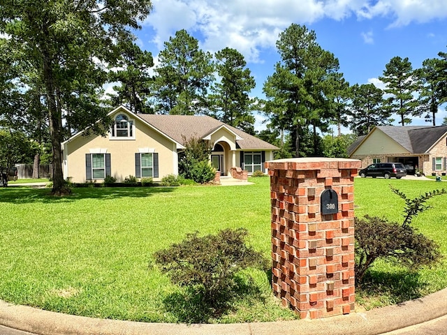 300 Deer Trace Blvd, Diboll, TX 75941 - ranch-style house with a front lawn and stucco siding