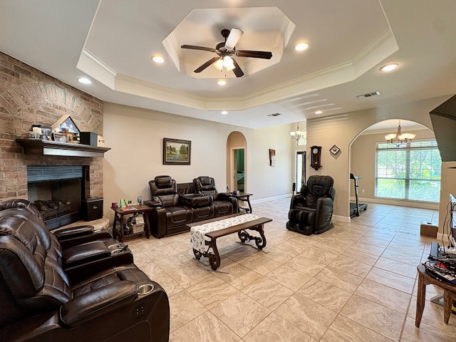 300 Deer Trace Blvd, Diboll, TX 75941 - living room featuring arched walkways, a tray ceiling, crown molding, a chandelier, and a ceiling fan