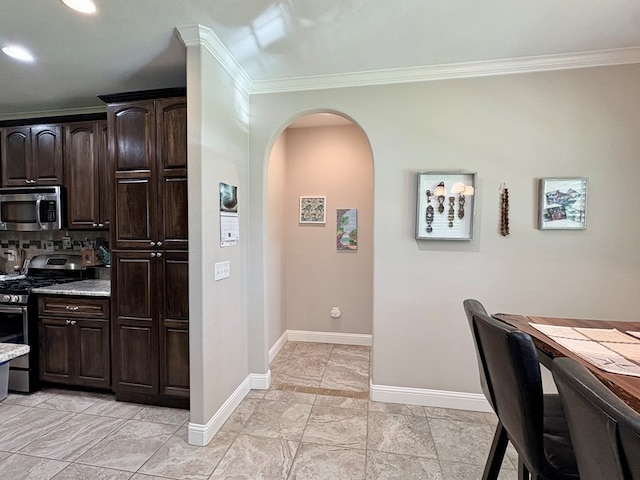 300 Deer Trace Blvd, Diboll, TX 75941 - kitchen featuring stainless steel appliances, arched walkways, crown molding, dark brown cabinets, and recessed lighting