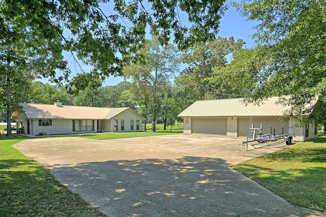 ranch-style house featuring a front yard and a garage