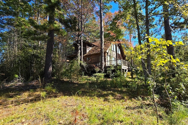 view of side of home featuring a wooden deck