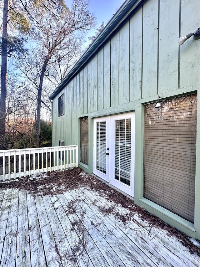 snow covered deck featuring french doors