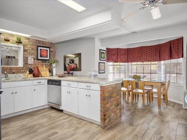 kitchen with ceiling fan, dishwasher, kitchen peninsula, light hardwood / wood-style floors, and white cabinets