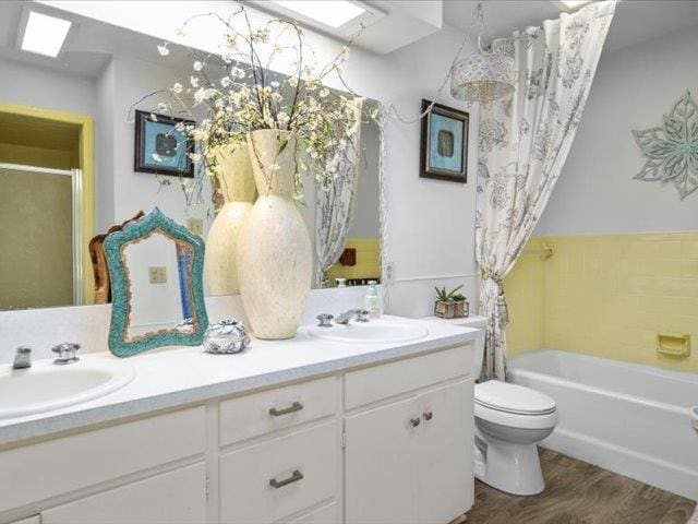 full bathroom with vanity, hardwood / wood-style flooring, toilet, and independent shower and bath