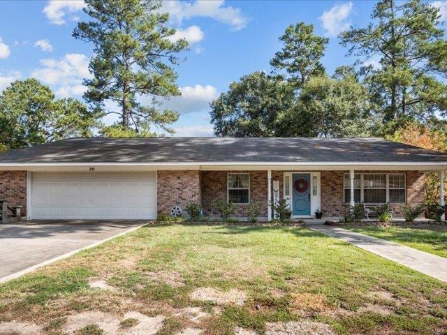 single story home featuring a front yard, a garage, and covered porch