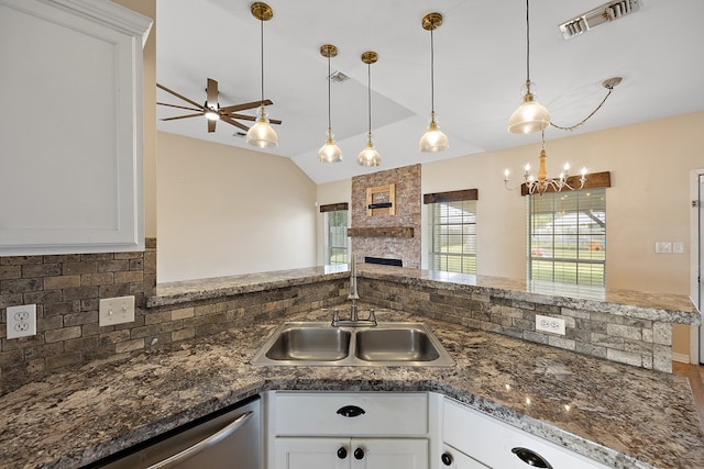 kitchen with tasteful backsplash, ceiling fan, sink, decorative light fixtures, and white cabinetry