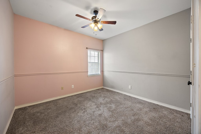 carpeted spare room with ceiling fan