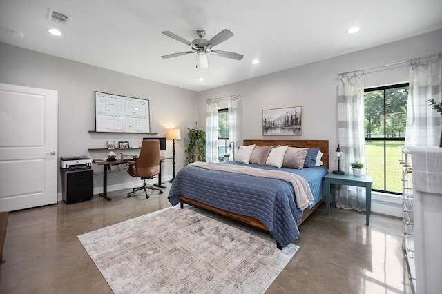 bedroom with recessed lighting, concrete flooring, and multiple windows