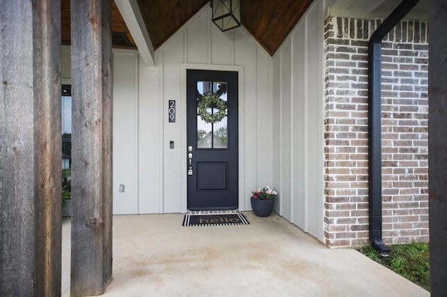 entrance to property with brick siding and board and batten siding