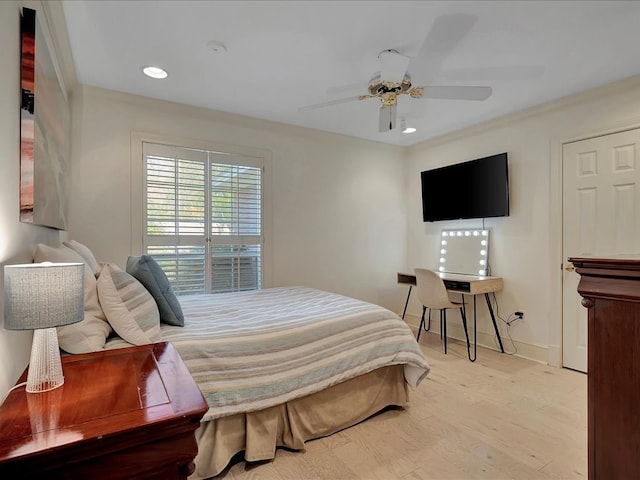 bedroom featuring light hardwood / wood-style floors, ceiling fan, and ornamental molding