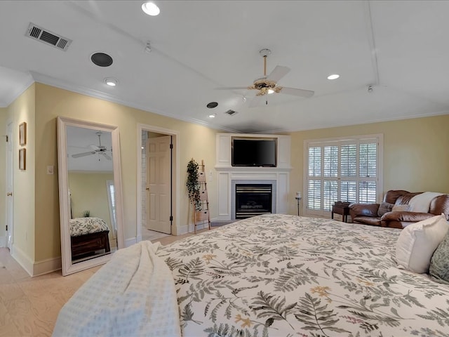 bedroom featuring ceiling fan, light hardwood / wood-style floors, and ornamental molding