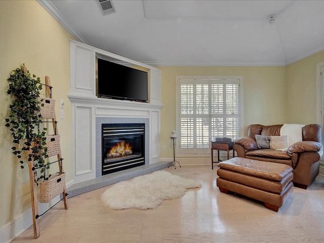 living room featuring a fireplace and crown molding