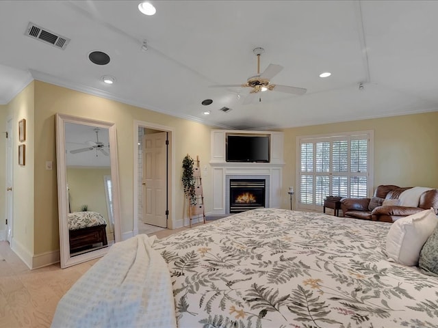 bedroom featuring ceiling fan, ornamental molding, and light hardwood / wood-style flooring