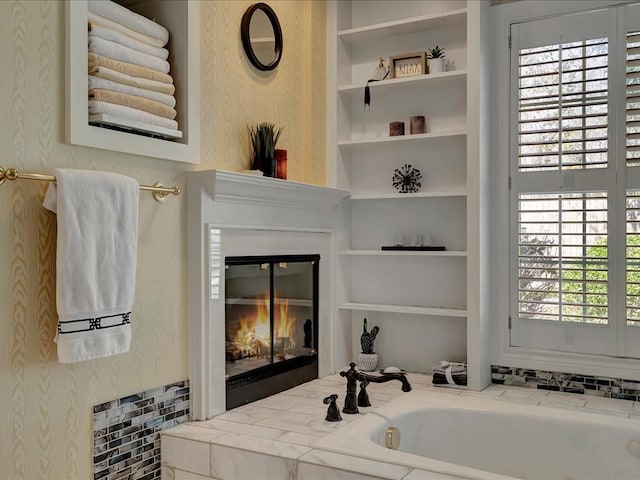 bathroom featuring a tub and built in features