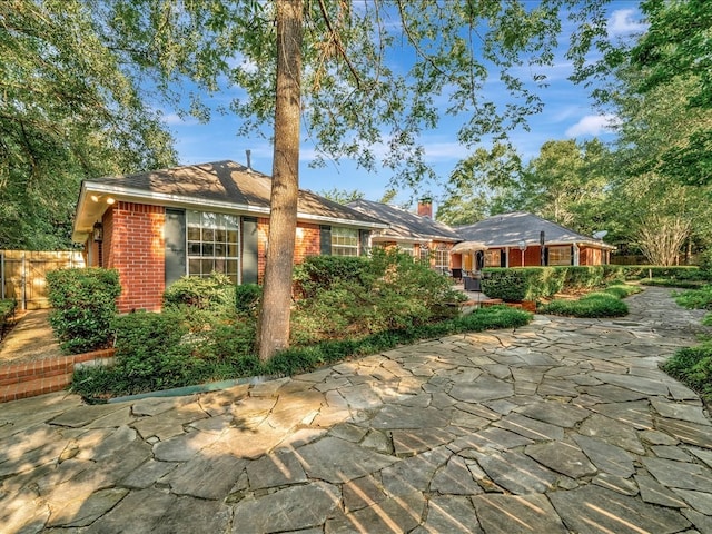 ranch-style home featuring a patio area