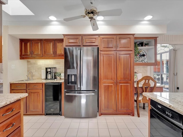 kitchen featuring sink, beverage cooler, light stone counters, stainless steel fridge, and ornamental molding