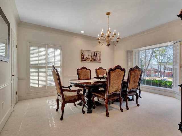 dining area featuring a wealth of natural light, ornamental molding, light colored carpet, and an inviting chandelier