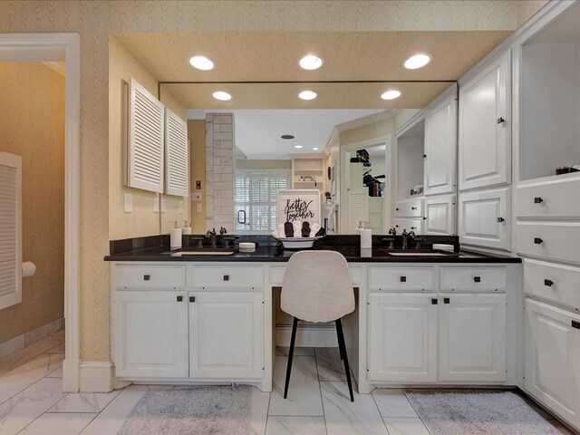 kitchen with white cabinetry and sink