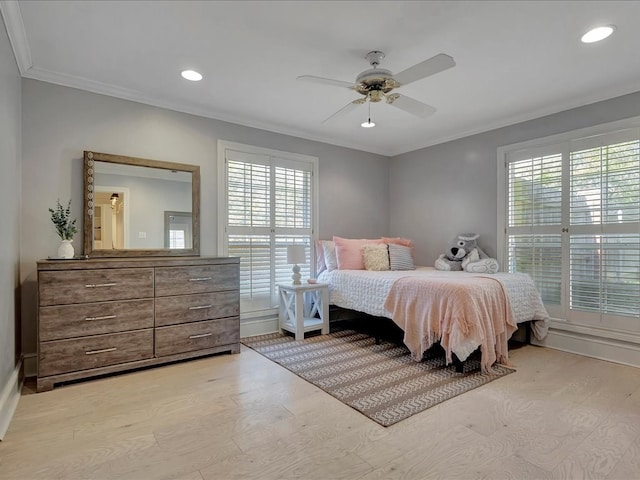 bedroom featuring ceiling fan, ornamental molding, and light hardwood / wood-style flooring