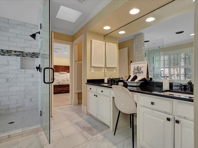 bathroom with a skylight, crown molding, vanity, and an enclosed shower