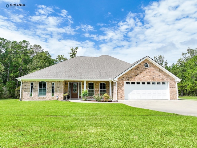 view of front of home with covered porch, a front yard, and a garage