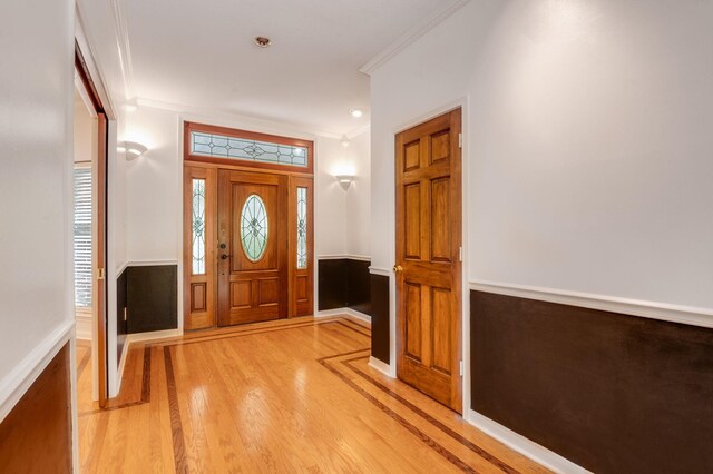 entrance foyer with light wood-type flooring and crown molding