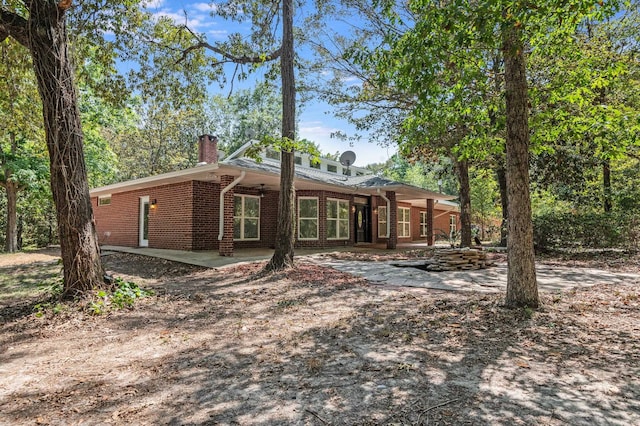 view of side of home featuring a patio area