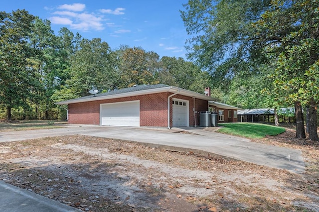 exterior space with a garage and central air condition unit