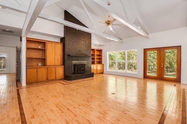 unfurnished living room featuring beamed ceiling, french doors, light hardwood / wood-style flooring, and ceiling fan