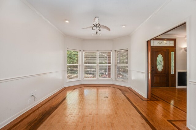 foyer entrance featuring crown molding, ceiling fan, and light hardwood / wood-style floors