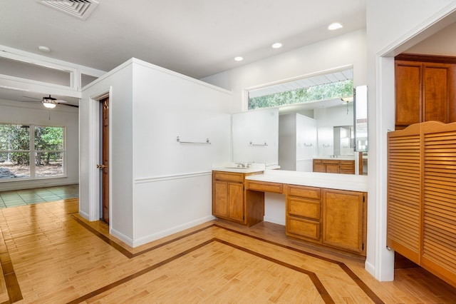 bathroom featuring hardwood / wood-style floors, ceiling fan, and vanity