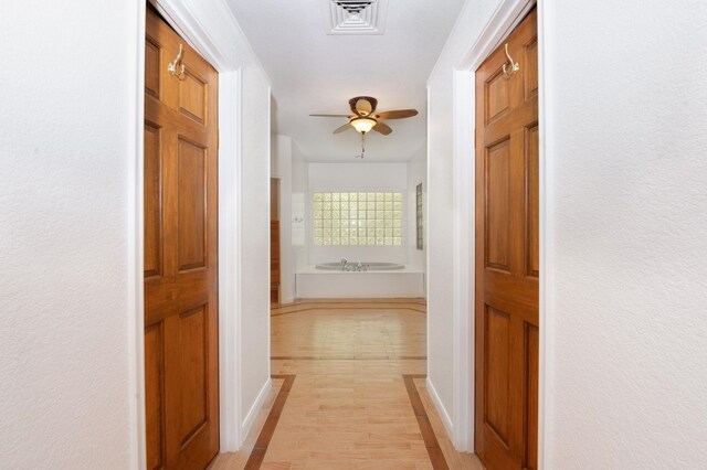 hall with light wood-type flooring