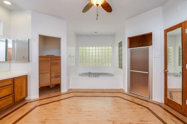 bathroom featuring hardwood / wood-style floors, vanity, shower with separate bathtub, and ceiling fan