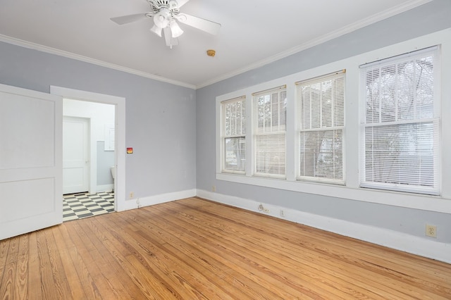 unfurnished room featuring ceiling fan, crown molding, baseboards, and wood finished floors