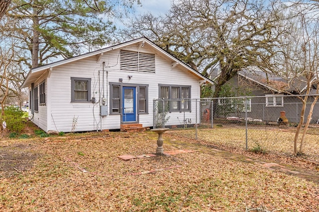 bungalow-style house with entry steps and fence