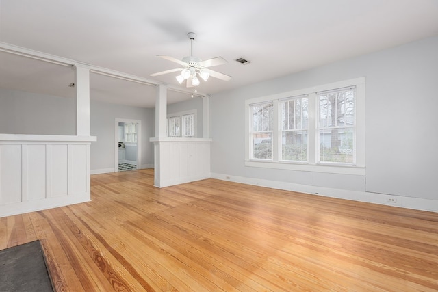 empty room with visible vents, baseboards, a ceiling fan, and light wood-style floors