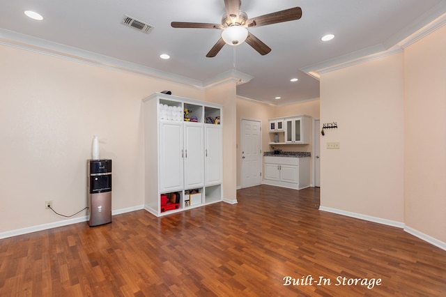 interior space with ceiling fan, crown molding, and dark wood-type flooring