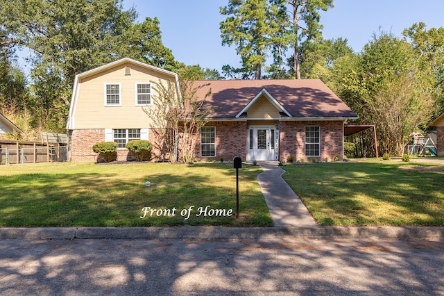 view of front facade with a front lawn and a carport