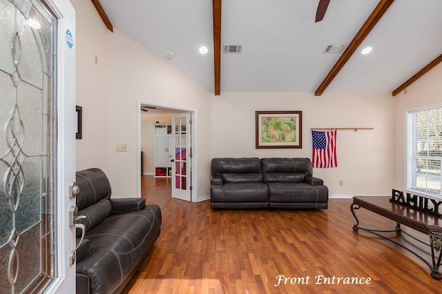 living room featuring lofted ceiling with beams, ceiling fan, dark wood-type flooring, and french doors