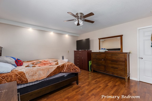 bedroom with a textured ceiling, dark hardwood / wood-style flooring, and ceiling fan