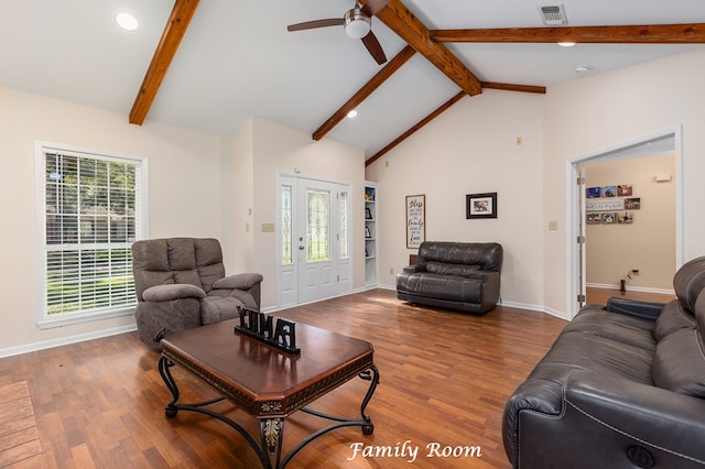 living area with baseboards, lofted ceiling with beams, visible vents, ceiling fan, and wood finished floors